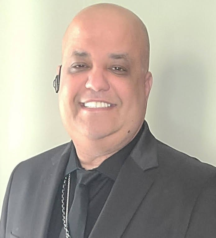 Brother James Lake, smiling, in a dark suit